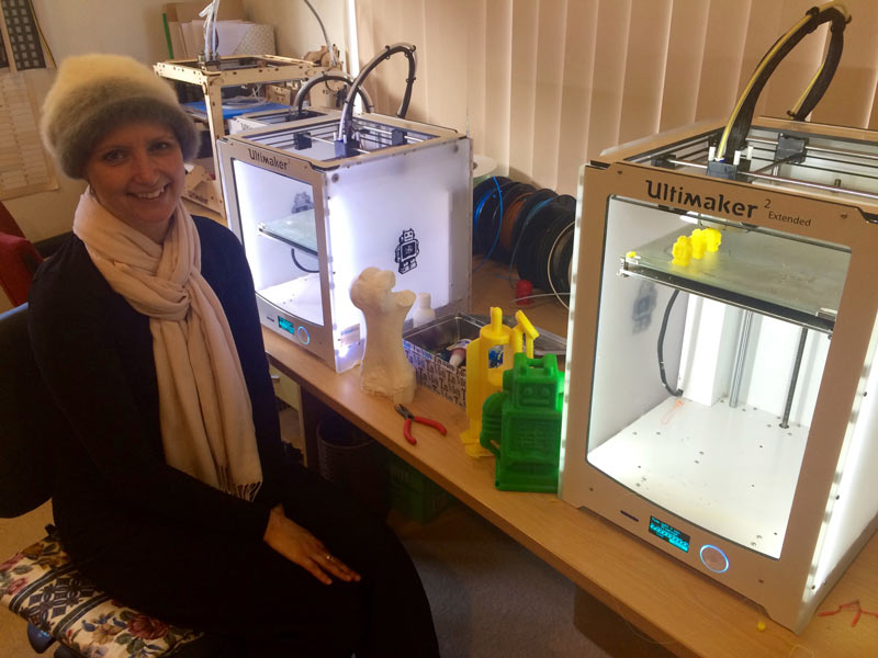 Fay sitting next to two Ultimaker 3D printers